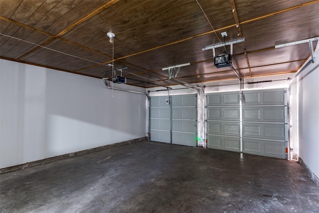 garage with a garage door opener and baseboards