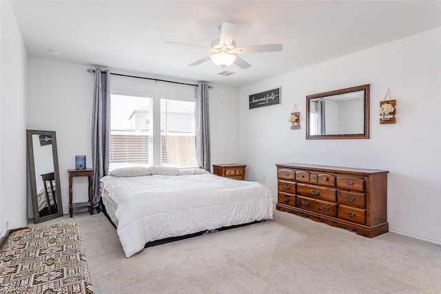 carpeted bedroom featuring visible vents and a ceiling fan