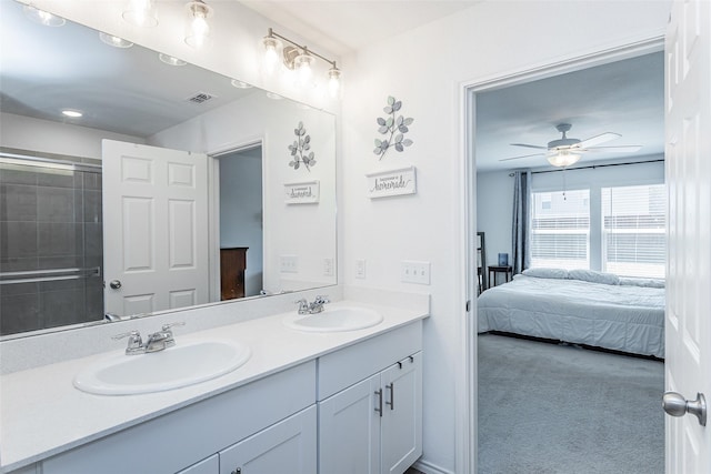 ensuite bathroom featuring double vanity, visible vents, ensuite bathroom, and a sink