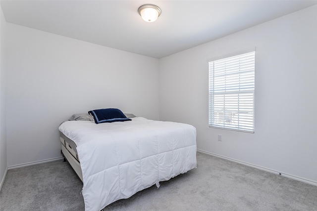 bedroom featuring baseboards and carpet flooring