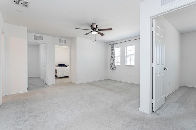 unfurnished bedroom with visible vents and light colored carpet