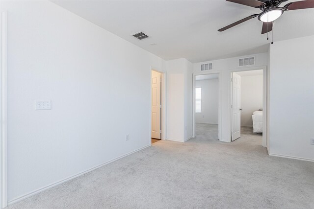 unfurnished bedroom featuring visible vents, baseboards, light colored carpet, and ceiling fan