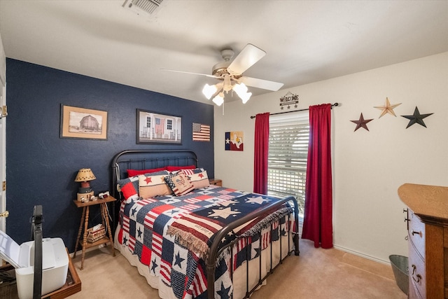 bedroom with a ceiling fan, visible vents, and light carpet