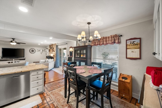 dining room with visible vents, crown molding, recessed lighting, ceiling fan with notable chandelier, and brick floor