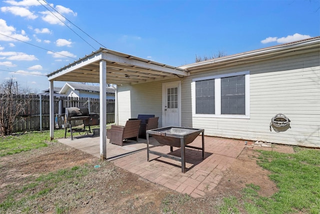 view of patio featuring a grill, an outdoor fire pit, and fence