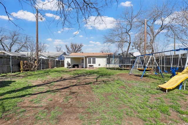 view of yard with a playground, a trampoline, and a fenced backyard