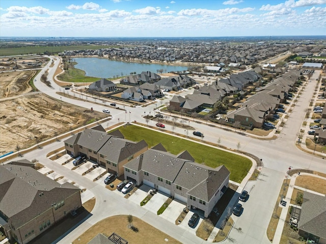 birds eye view of property with a water view and a residential view