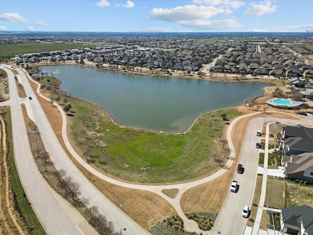 drone / aerial view featuring a residential view and a water view