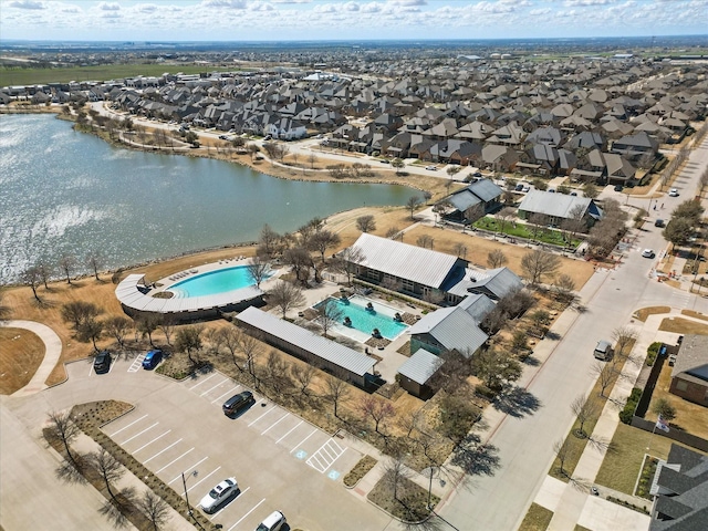 drone / aerial view with a residential view and a water view