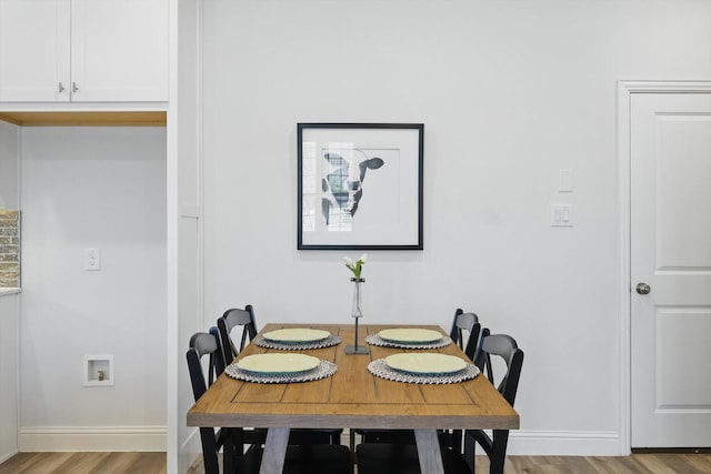 dining space with light wood-style floors and baseboards