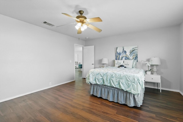 bedroom featuring visible vents, ceiling fan, baseboards, and wood finished floors