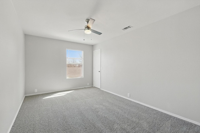 spare room featuring visible vents, baseboards, carpet, and ceiling fan