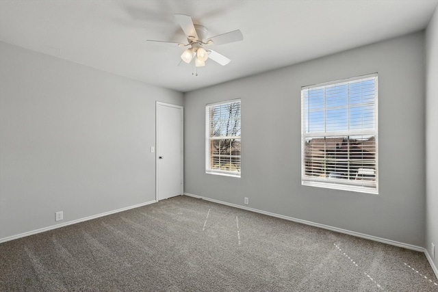 carpeted empty room with baseboards and ceiling fan