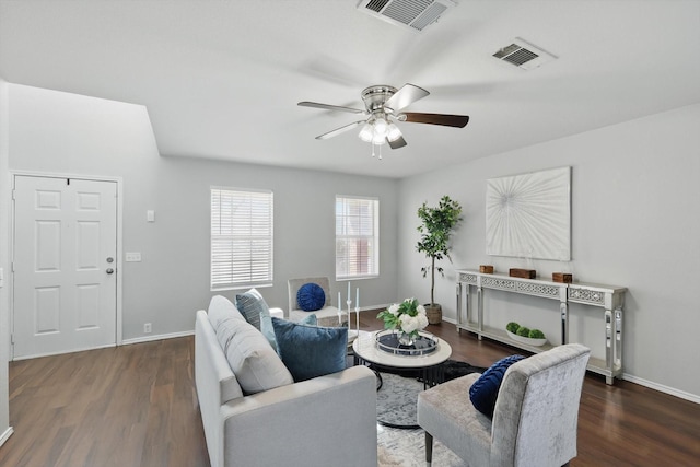 living area with visible vents, baseboards, a ceiling fan, and wood finished floors