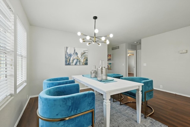 dining room featuring visible vents, an inviting chandelier, wood finished floors, and a healthy amount of sunlight