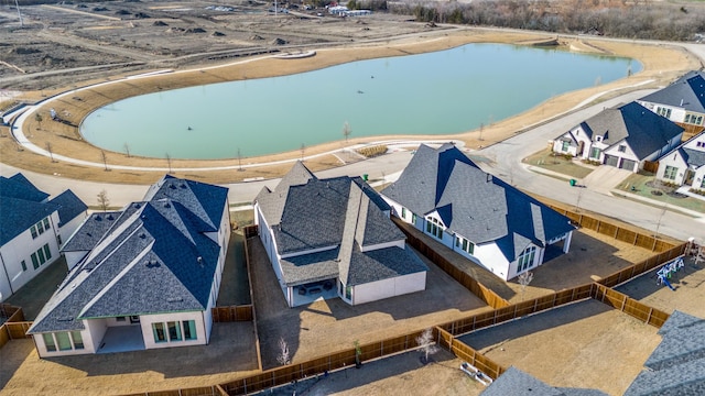 birds eye view of property with a water view and a residential view