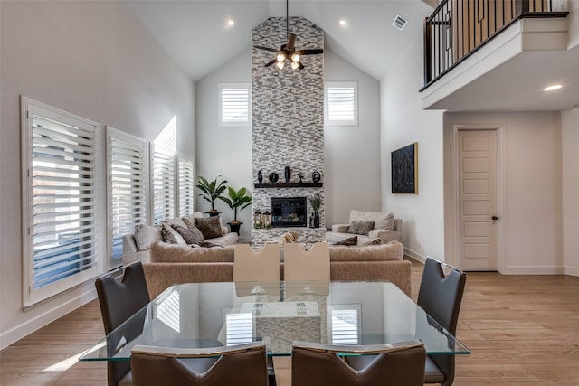 dining room with visible vents, high vaulted ceiling, light wood-style flooring, and a ceiling fan