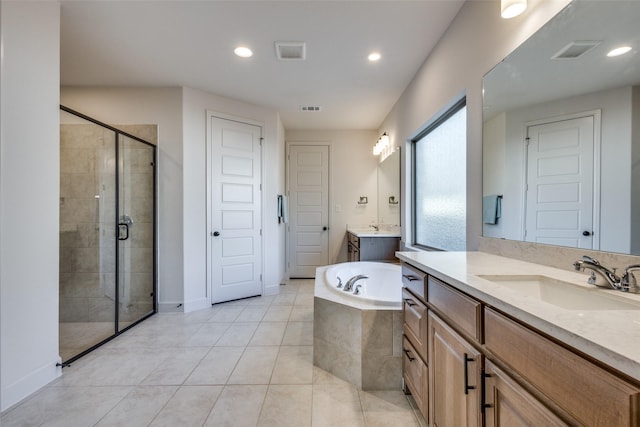 bathroom with a garden tub, visible vents, a stall shower, and a sink