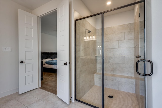 ensuite bathroom featuring ensuite bath, a stall shower, and tile patterned flooring