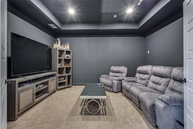 carpeted home theater room featuring visible vents, recessed lighting, and a tray ceiling