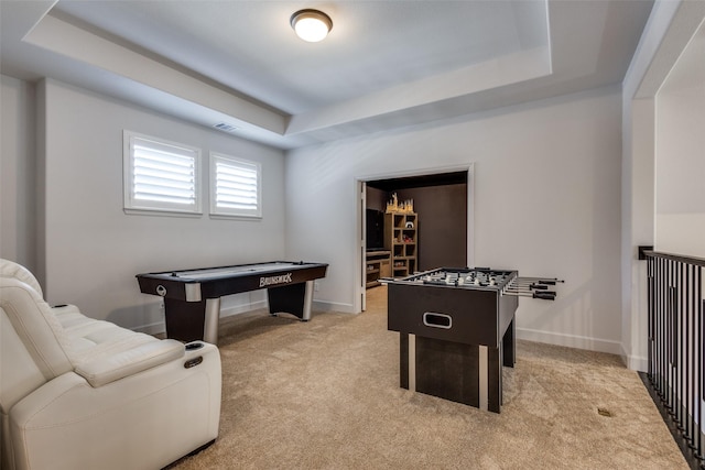 game room featuring light carpet, visible vents, baseboards, and a tray ceiling