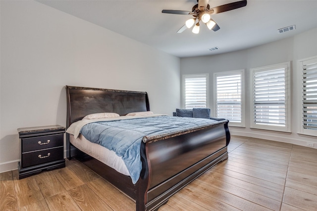 bedroom featuring visible vents, baseboards, and light wood-style floors