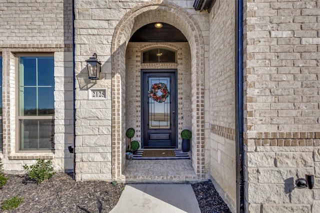 property entrance featuring brick siding