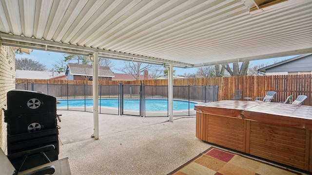 view of swimming pool featuring a fenced backyard, a fenced in pool, a hot tub, and a patio