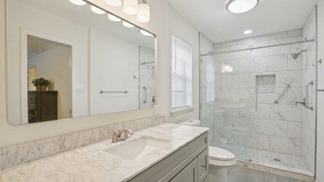 full bath featuring vanity, toilet, and a stall shower