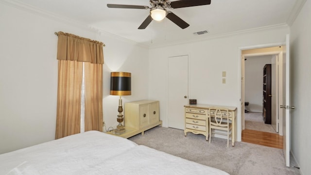 bedroom featuring visible vents, ceiling fan, crown molding, and carpet