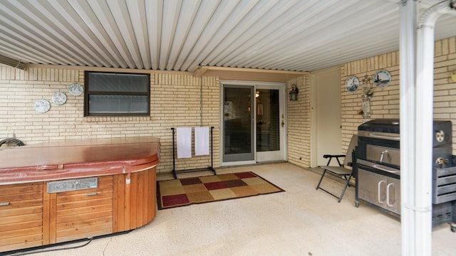 view of patio with grilling area and a hot tub