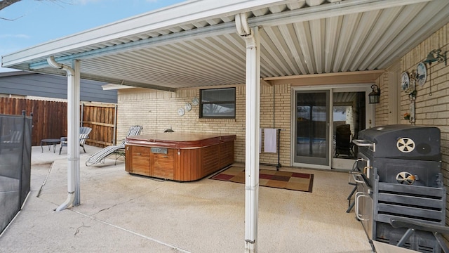 view of patio with fence and a grill