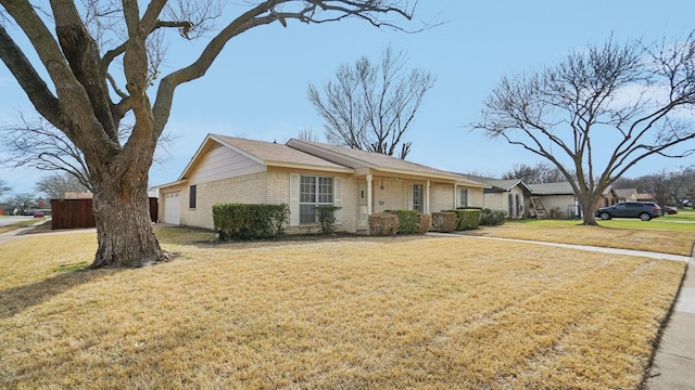 single story home featuring brick siding and a front lawn