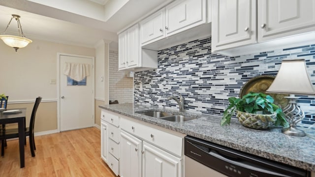 kitchen featuring dishwasher, white cabinets, ornamental molding, and a sink