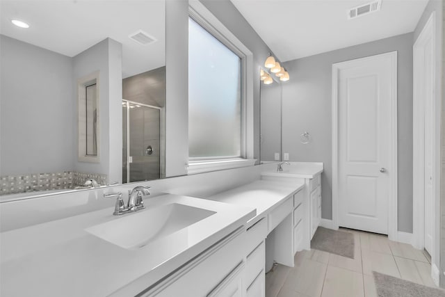 bathroom featuring tile patterned flooring, visible vents, a stall shower, and vanity