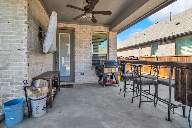 view of patio with a ceiling fan, fence, and a grill