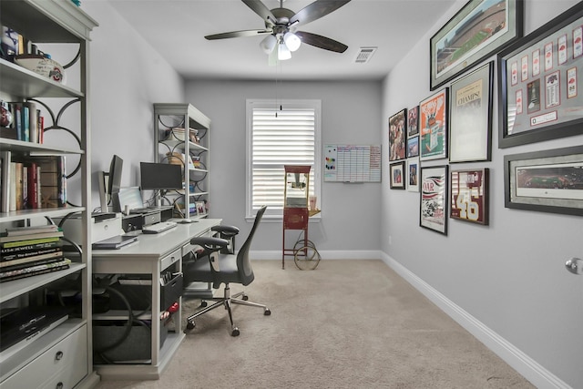 carpeted office with visible vents, baseboards, and ceiling fan