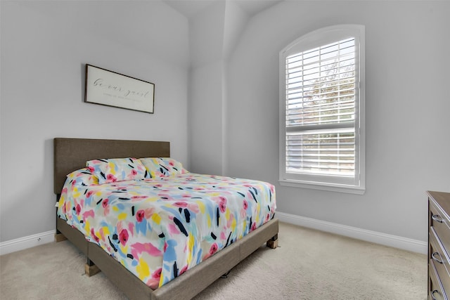 bedroom featuring baseboards and carpet