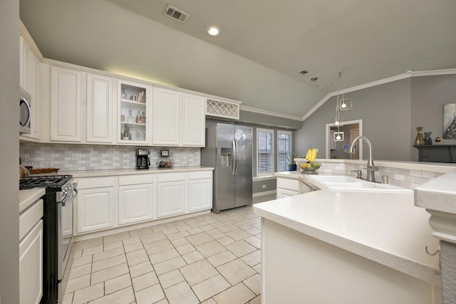 kitchen featuring decorative backsplash, visible vents, crown molding, appliances with stainless steel finishes, and a sink