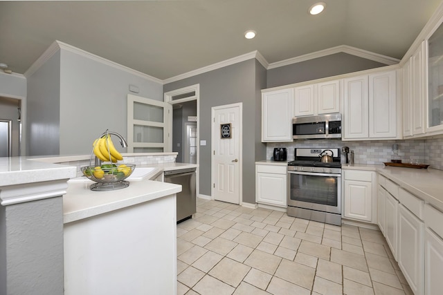 kitchen with light countertops, decorative backsplash, white cabinets, and stainless steel appliances