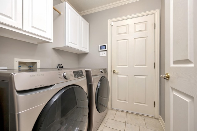 laundry area featuring crown molding, cabinet space, independent washer and dryer, and light tile patterned floors