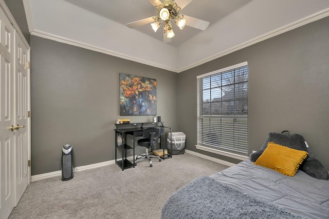 carpeted bedroom featuring crown molding, baseboards, and a ceiling fan