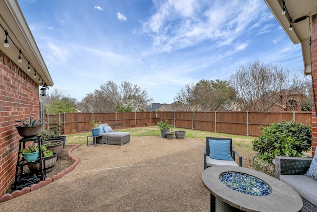 view of patio / terrace featuring a fenced backyard and an outdoor fire pit