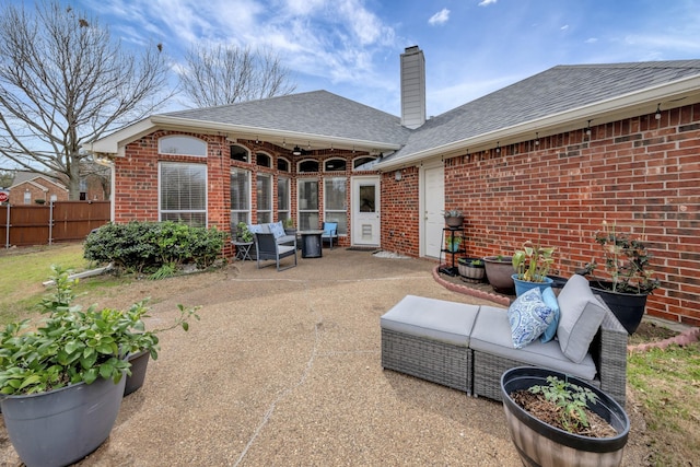 back of house with brick siding, fence, a chimney, and a patio