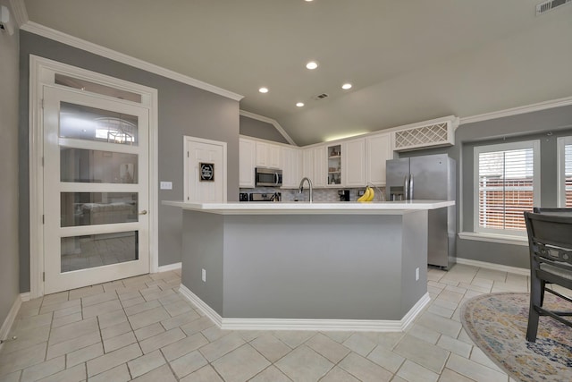 kitchen with crown molding, light countertops, lofted ceiling, stainless steel appliances, and recessed lighting