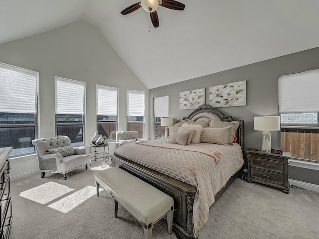 bedroom featuring light colored carpet, baseboards, and a ceiling fan