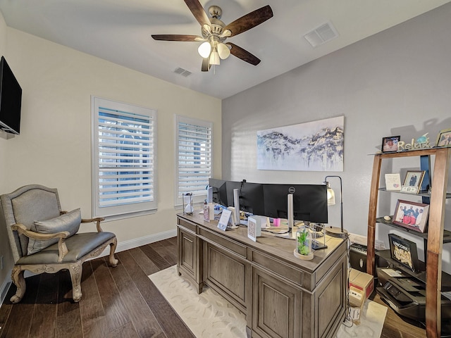 office featuring a ceiling fan, visible vents, light wood finished floors, and baseboards