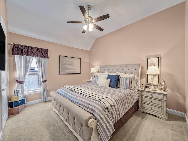 bedroom featuring vaulted ceiling, a ceiling fan, baseboards, and light carpet