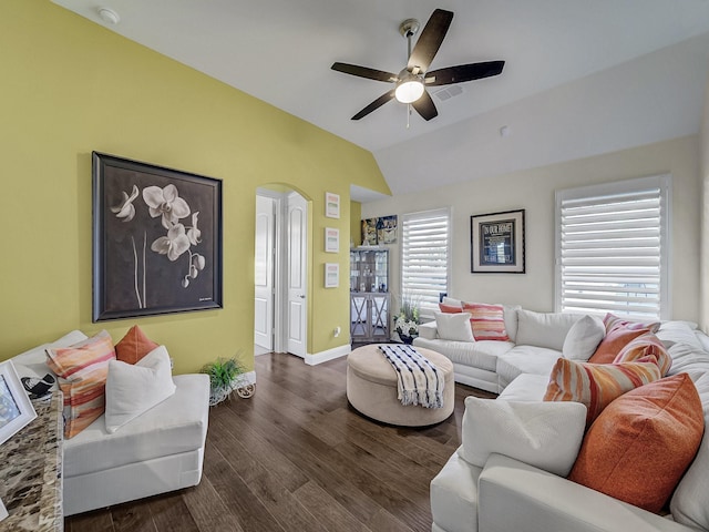 living room with baseboards, dark wood finished floors, lofted ceiling, arched walkways, and ceiling fan