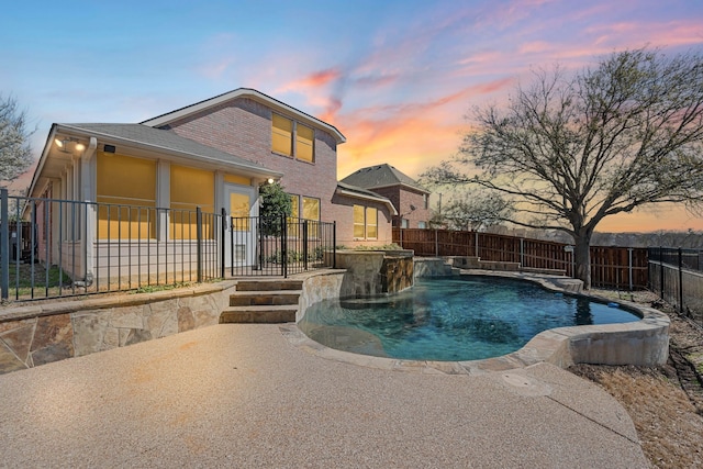 pool at dusk featuring a fenced in pool, a patio, and a fenced backyard